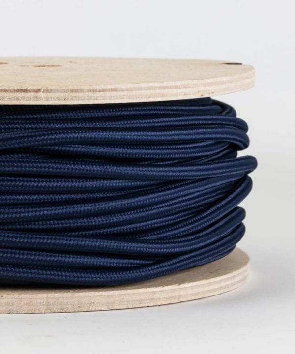 closeup of navy fabric cable on reel against white background