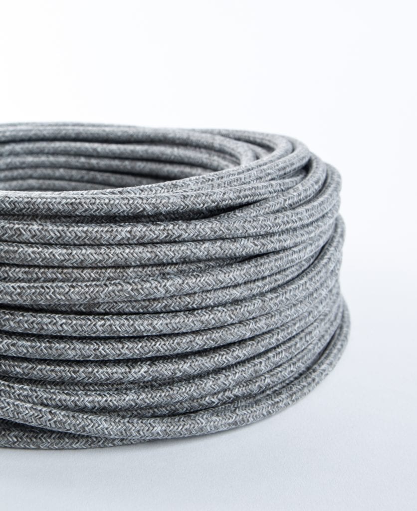 closeup of grey jumper fabric cable coil against white background
