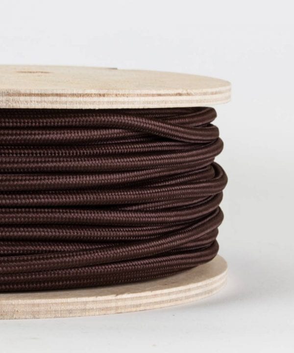 closeup of brown fabric cable on reel against white background