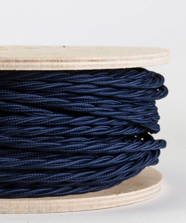 closeup of navy twsited fabric cable on reel against white background