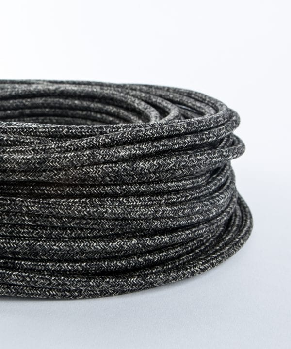 closeup of fisherman's jumper fabric cable coil against white background