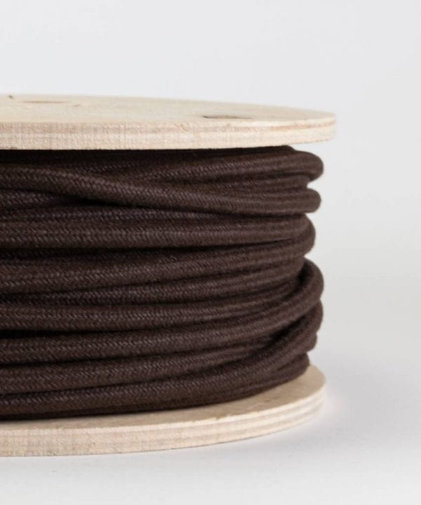 closeup of matt brown fabric cable on reel against white background