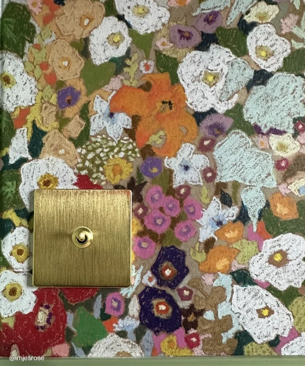 A Gold Toggle Switch on a floral wallpaper background