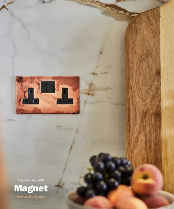 tarnished copper double socket adds a glamorous metallic touch to the kitchen