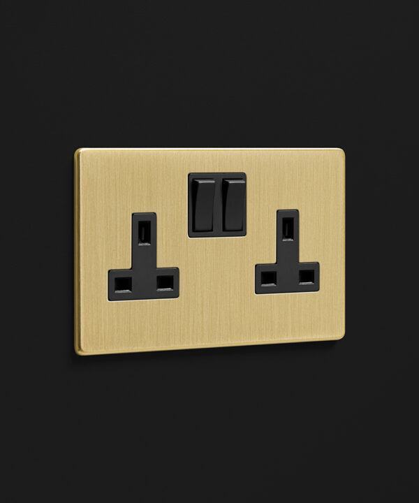 gold double socket on a black wall