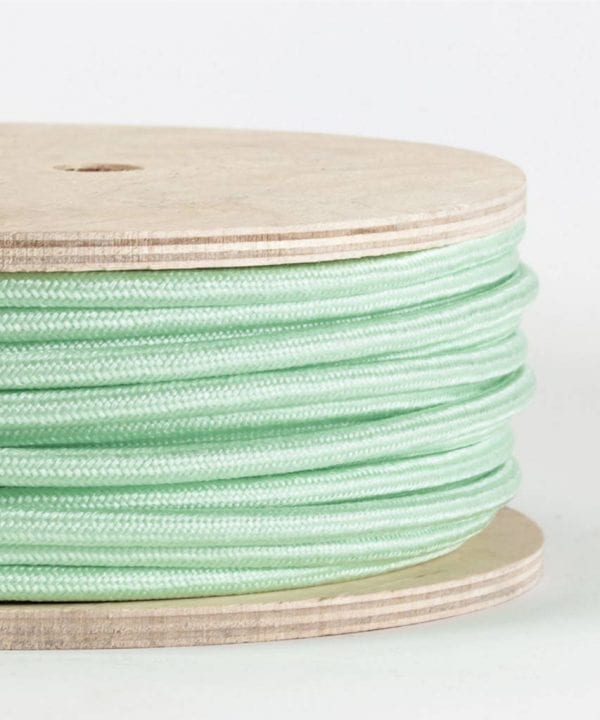 closeup of neo mint fabric cable on reel against white background