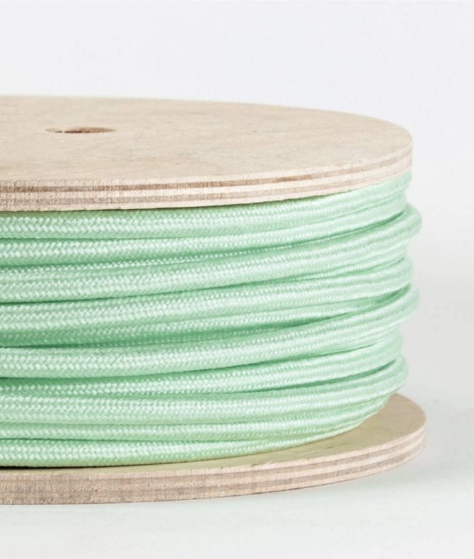 closeup of neo mint fabric cable on reel against white background
