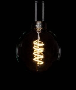 large globe spiral filament led light bulbs against black background