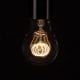 LED filament bulbs quad loop warm glow bulb against a black background