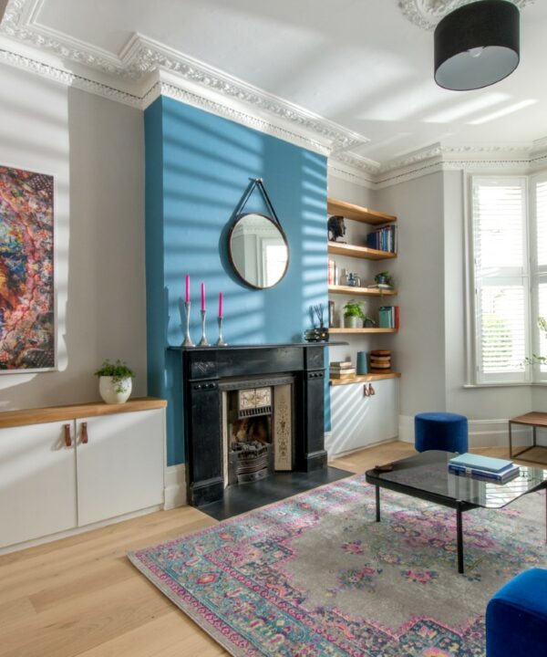 large dark tan magni handle installed on white inbui;t cupboards one either side of a black fireplace.