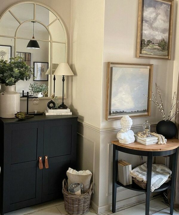 magni dark tan and gold handles gitted on a black cupboard in an off-white space