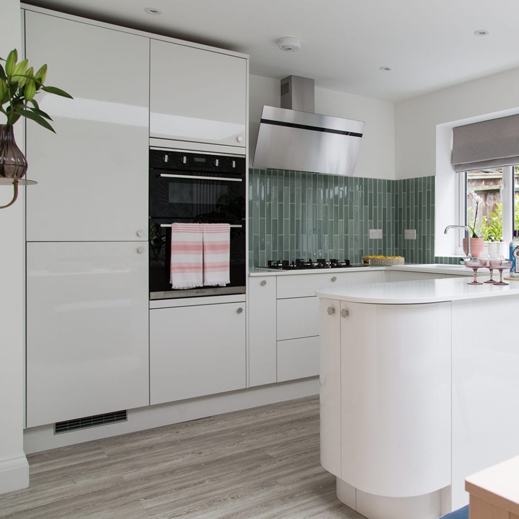 silver bauhaus hexagonal knobs on white kitchen drawers and doors