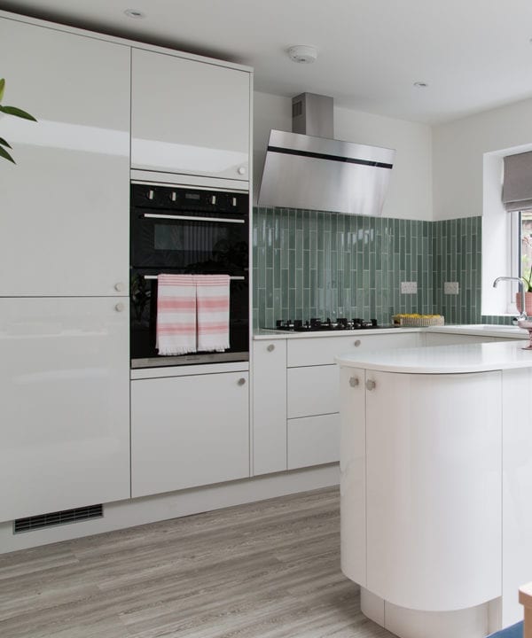 silver bauhaus hexagonal knobs on white kitchen drawers and doors
