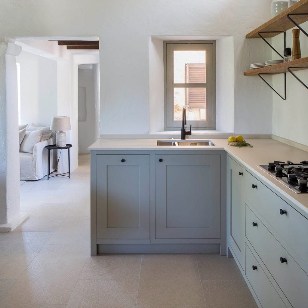 abstract knobs on light grey cupboards in grey and white kitchen