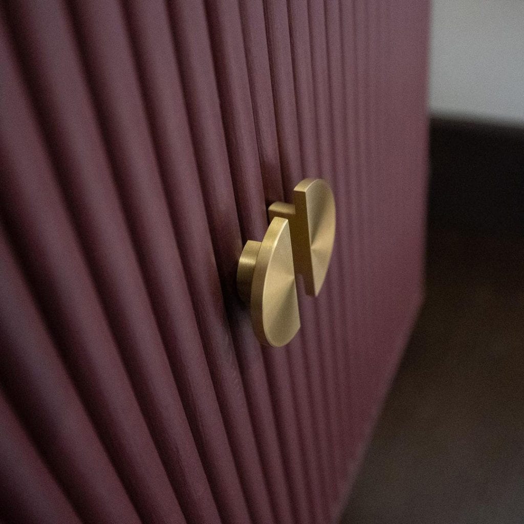 NOUVEAU gold semi-circular knob on mauve textured cupboard doors