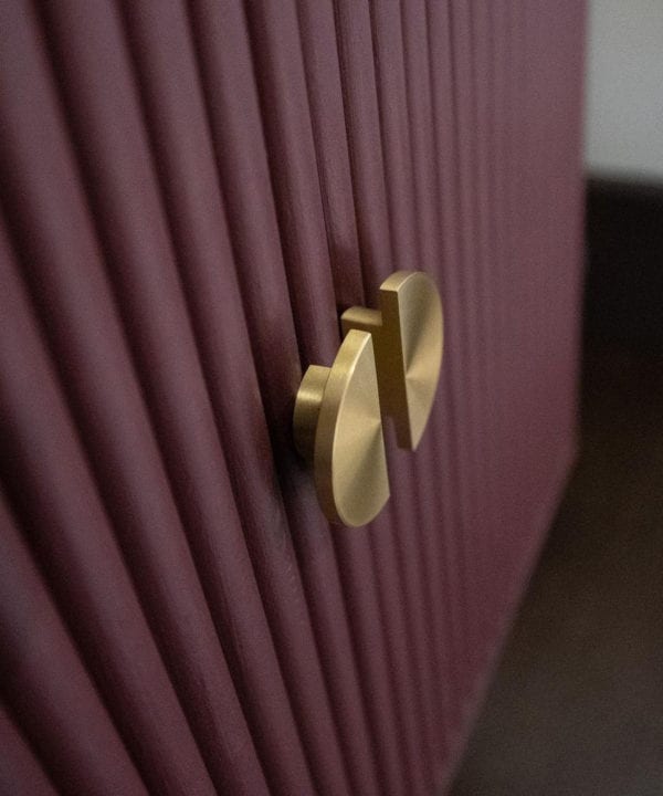 NOUVEAU gold semi-circular knob on mauve textured cupboard doors