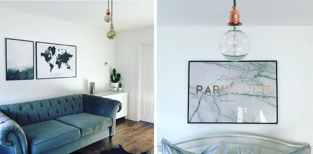 left image shows mirrored light bulbs suspended from copper bulb holders and black fabric cable in  white living room, with dark blue chesterfield sofa. right image shows closeup of mirrored bulbs in front of a marbled piece of artwork