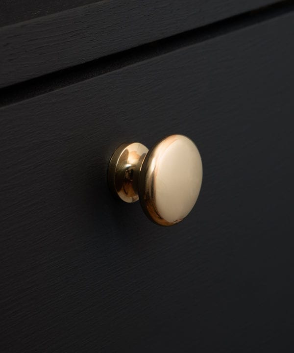 gold realist drawer knobs on a black drawer