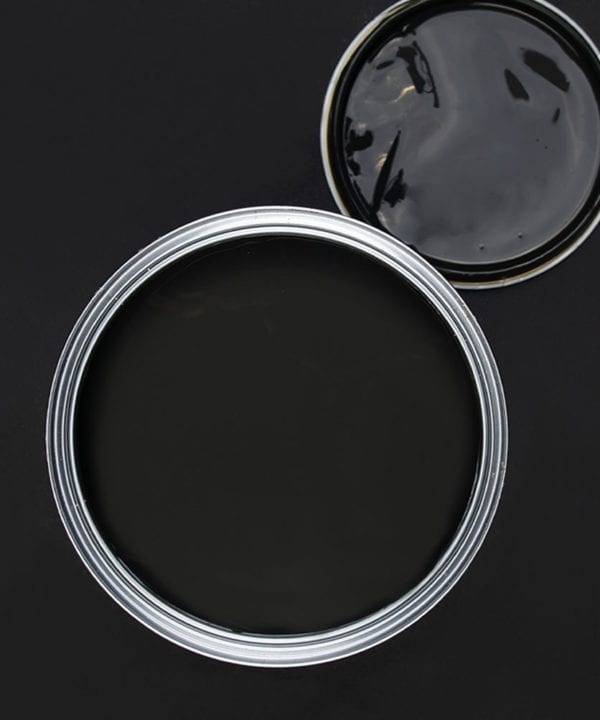All the lights off dark grey paint tin on dark background
