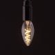 E14 LED candle bulbs with spiral filament against black background