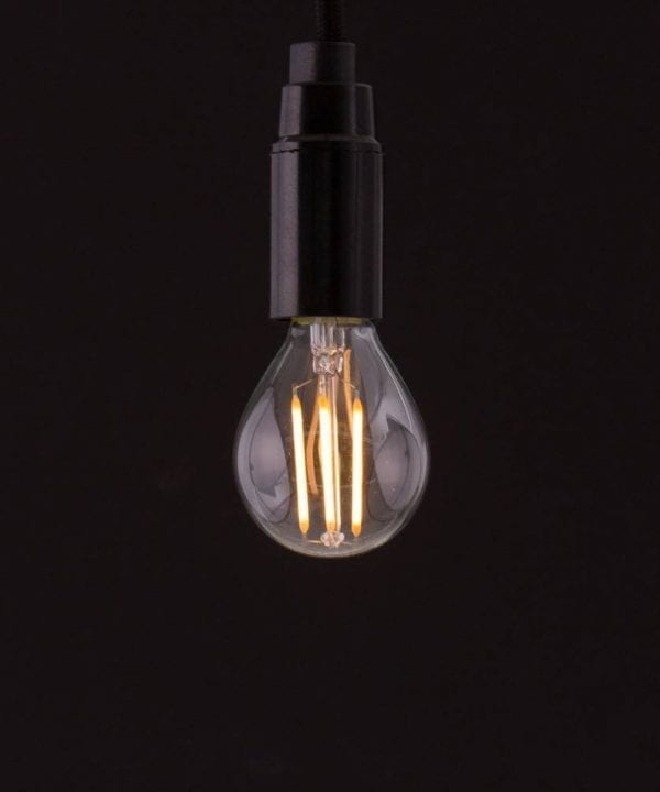 E14 LED bulb with squirrel cage filament against black background