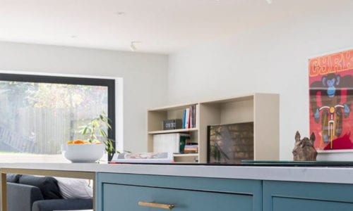 gold skyscraper door handles on blue cupboards in blue and white kitchen