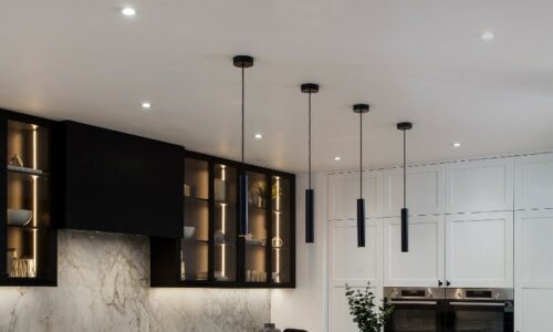 Baton kitchen lights hanging above a kitchen island unit