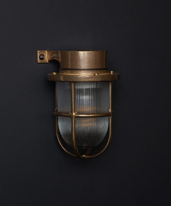 unlit brass simon exterior bulkhead lights against black background