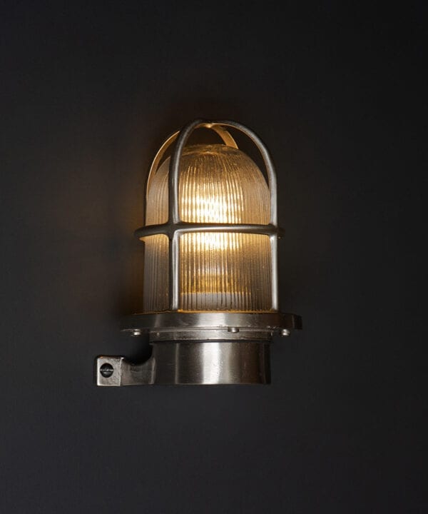 simon silver bulkhead light on black wall