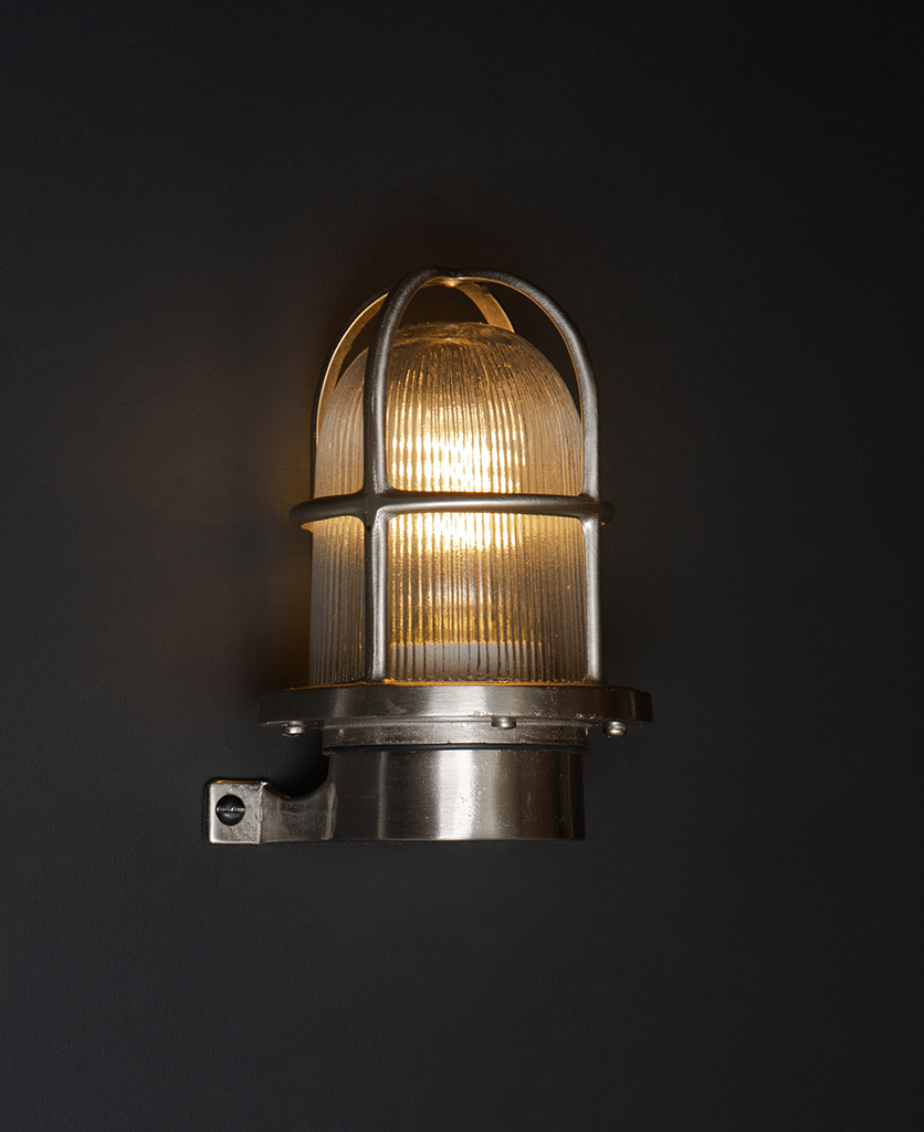 simon silver bulkhead light on black wall