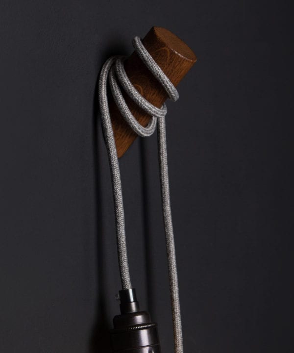 peg wall light oak and grey against black background
