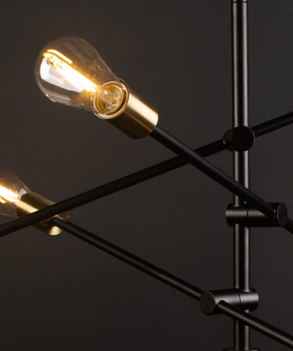 black modern chandelier with clear pear bulbs close up against black background