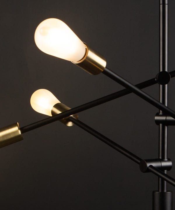 black modern chandelier with frosted pear bulbs close up against black background