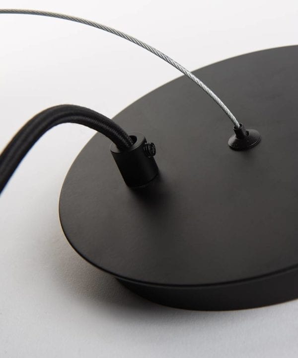 closeup of trikonasana black ceiling rose with silver suspension wire on white background