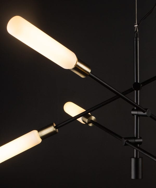 close up of black modern chandelier with luna opal bulbs on black background