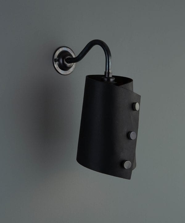 antique black wall sconce lighting with black leather light shade on grey wall