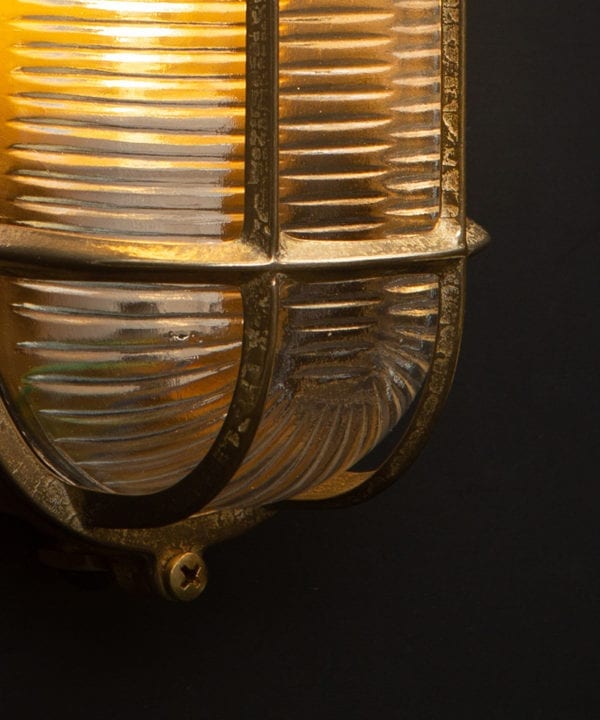 dave gold bulkhead wall light close up with bulb