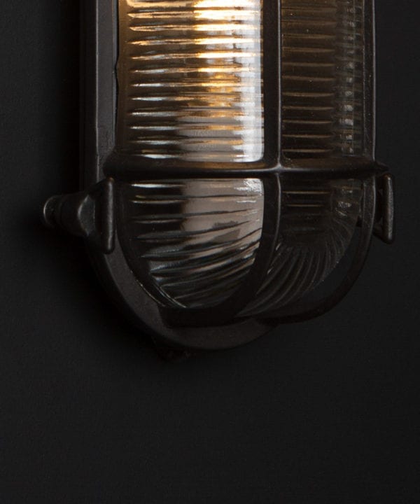 pewter steve bulkhead with wingnuts on black background with bulb close up
