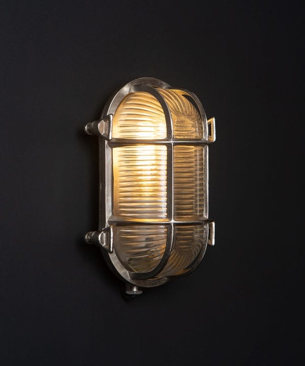 steve silver bulkhead outdoor lights with lit bulb against black background