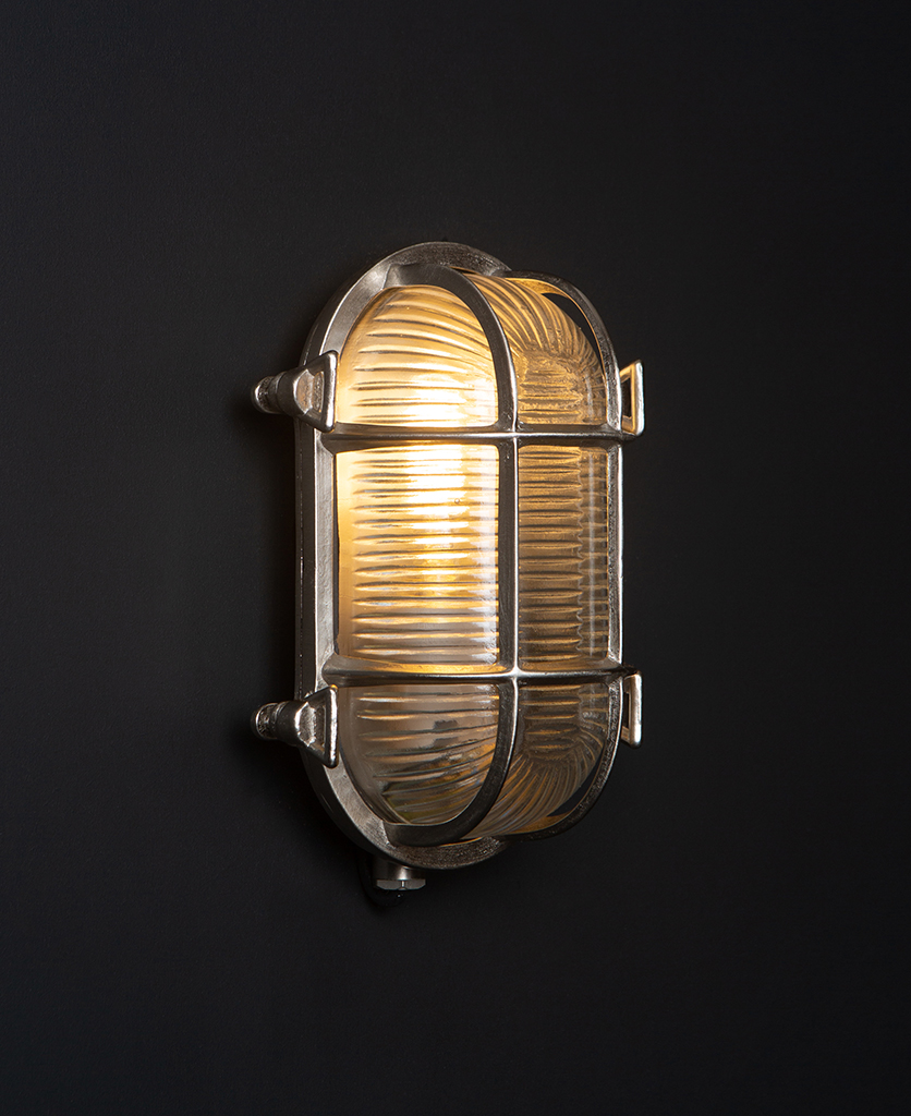 steve silver bulkhead outdoor lights with lit bulb against black background