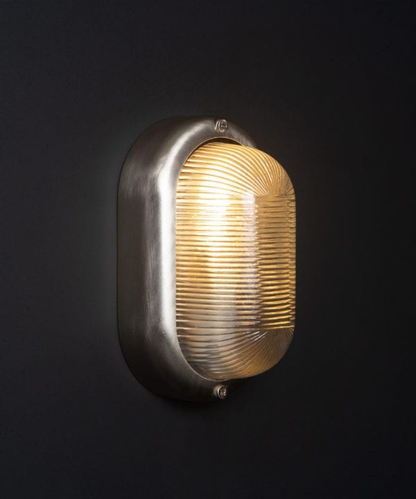 lit mike silver external led bulkhead light against black background