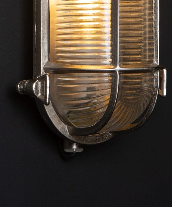 closeup of steve silver bulkhead outdoor lights with lit bulb against black background