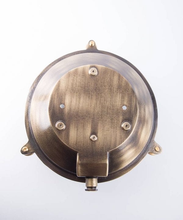 back view of chris aged brass bulkhead light against white background
