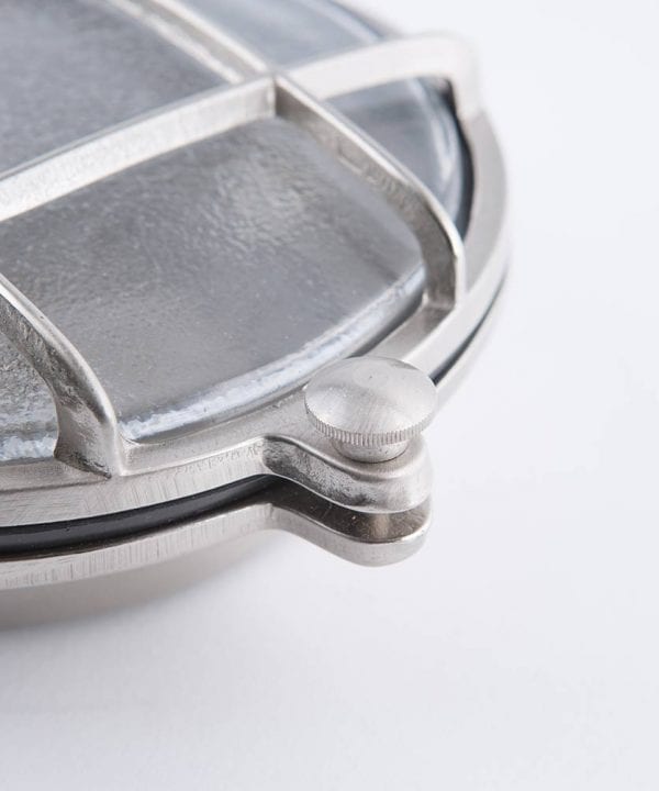 closeup of mark silver bulkhead light against white background