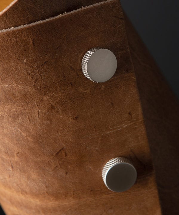 Tan and Silver Leather Cuff Table Lamp Close Up against black background