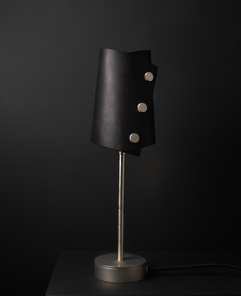 Black and Silver Leather Cuff Table Lamp against black background
