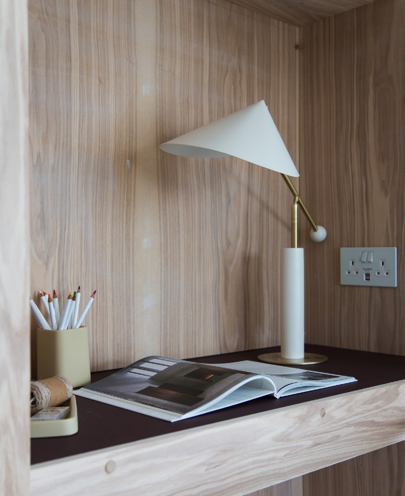 white double socket with usb installed on an inbuilt wooden desk