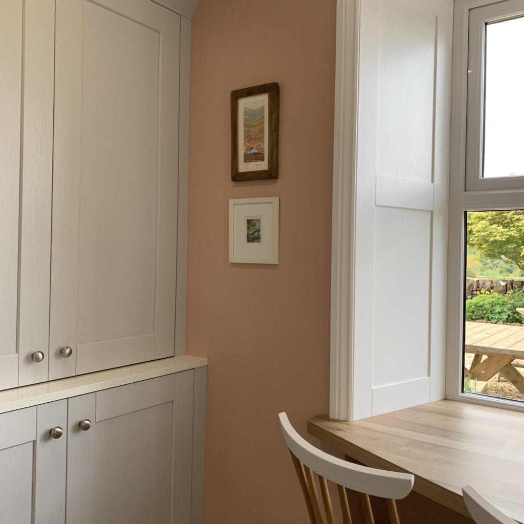 realist silver kitchen drawer knobs on soft grey cupboard doors in a room painted with get plastered paint