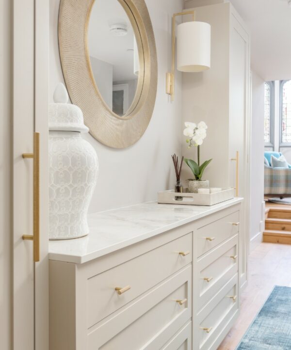 gold fixtures and fittings in a neutral grey bathroom