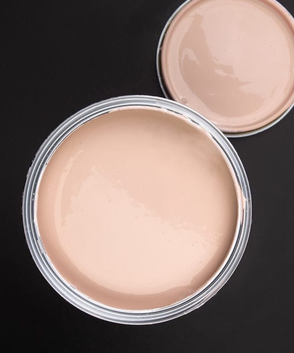 Get plastered dusky pink paint tin on dark background